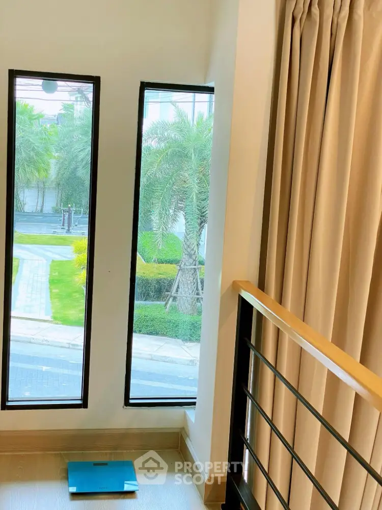 Modern interior with floor-to-ceiling windows and garden view