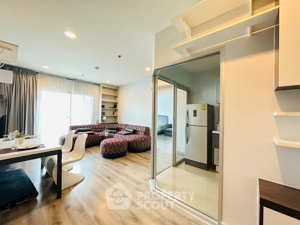 Modern open-plan living room with stylish furniture and kitchen area