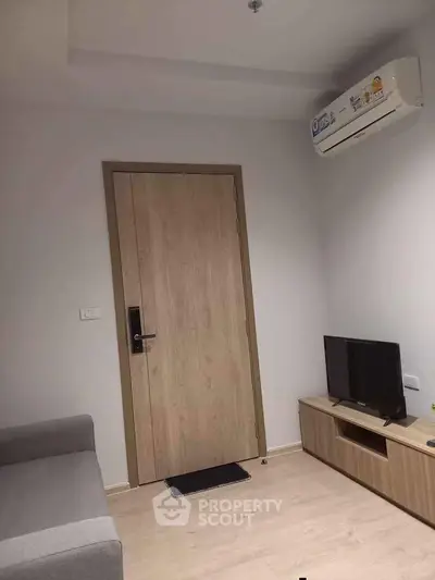 Modern living room with air conditioning and minimalist furniture design.