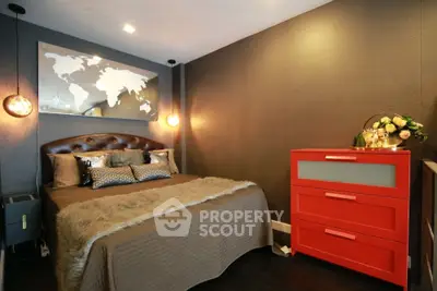 Stylish bedroom with modern decor and vibrant red dresser