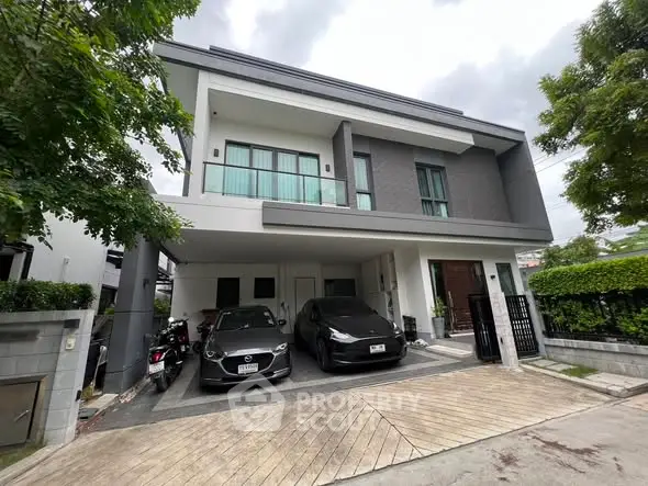 Modern two-story house with sleek design and spacious driveway in a serene neighborhood.