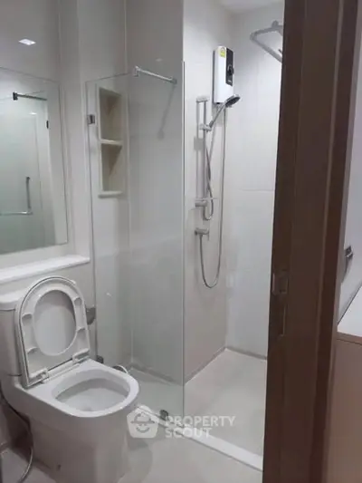 Modern bathroom with glass shower enclosure and sleek fixtures