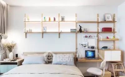 Modern bedroom with stylish shelving and cozy workspace, perfect for urban living.