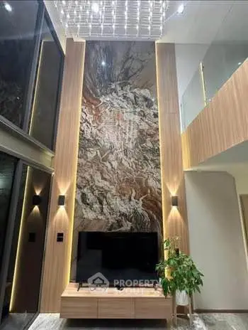 Luxurious modern living room with high ceiling and elegant wall design