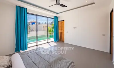 Spacious bedroom with pool view and modern design, featuring large windows and blue curtains.