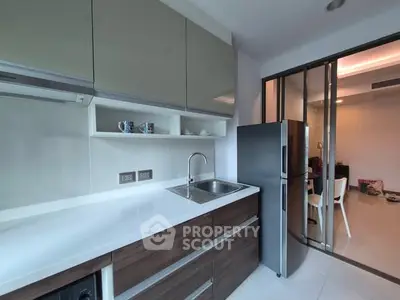 Modern kitchen with sleek cabinetry and stainless steel fridge