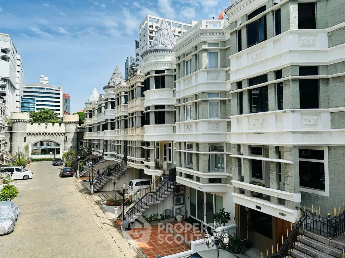 Stunning architectural exterior of luxury residential building with ornate design and spacious balconies.