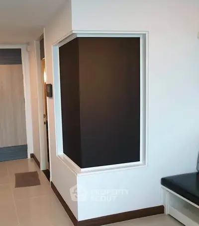Modern apartment interior with sleek design and neutral tones, featuring a stylish black accent wall.