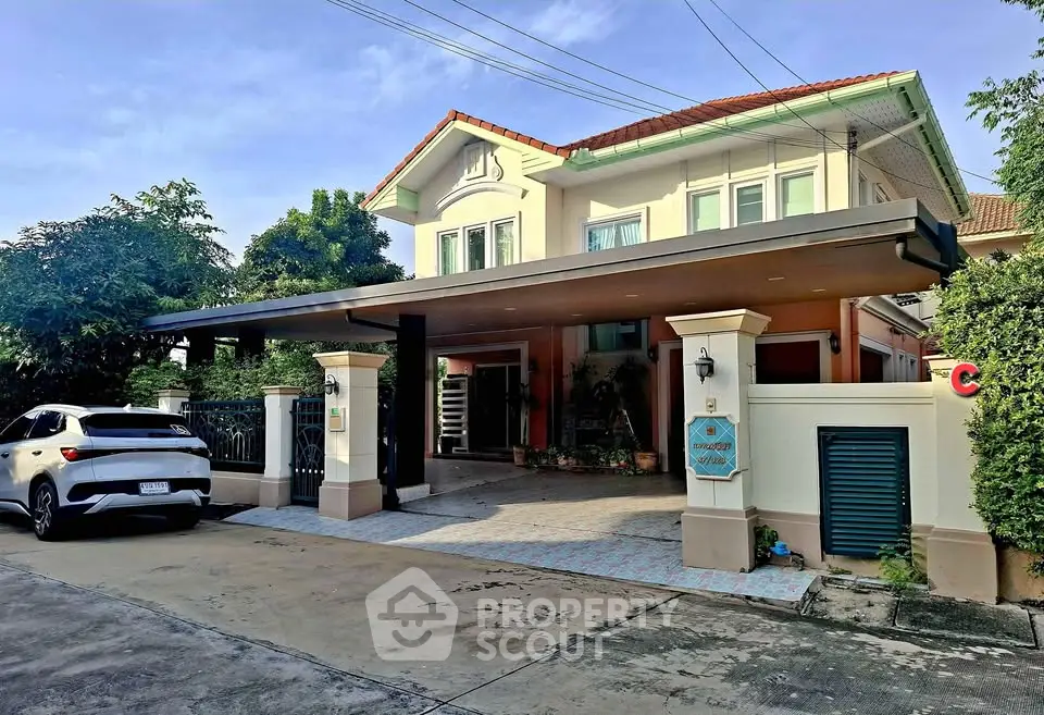 Charming two-story house with carport and lush greenery in a serene neighborhood.
