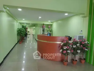 Spacious office reception area with modern decor and vibrant green walls