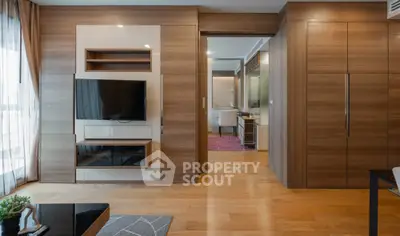 Modern living room with wooden accents and wall-mounted TV