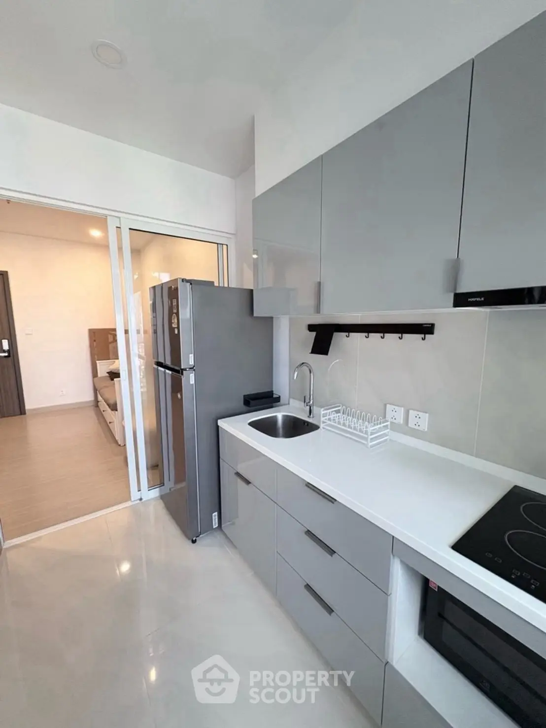 Modern kitchen with sleek cabinetry and built-in appliances in a stylish apartment.