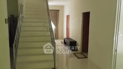 Spacious interior with staircase and polished floors in modern home