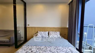 Modern bedroom with balcony access and stylish decor