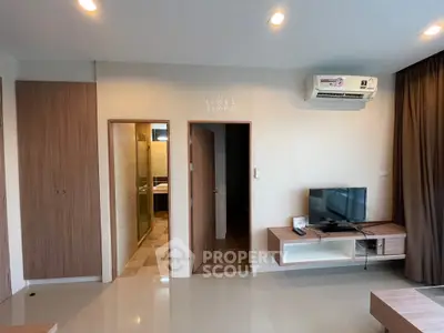 Modern living room with sleek furniture and air conditioning unit