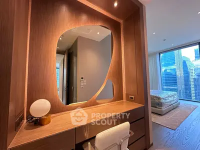Luxurious modern bedroom with wooden accents and city view, featuring a stylish vanity area.
