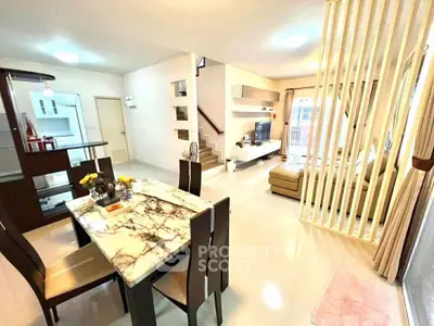 Spacious open-plan living and dining area with modern decor and natural light.