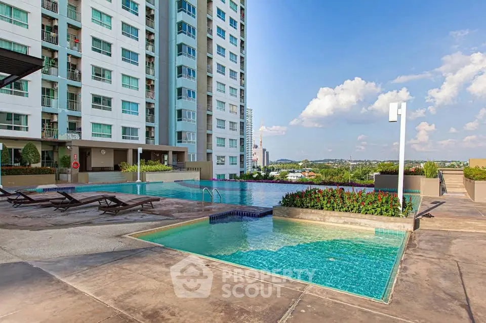 Luxurious high-rise apartment with stunning pool and panoramic city views.