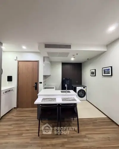 Modern open-layout kitchen with washing machine and stylish decor