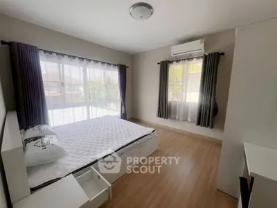 Spacious bedroom with large windows and modern decor