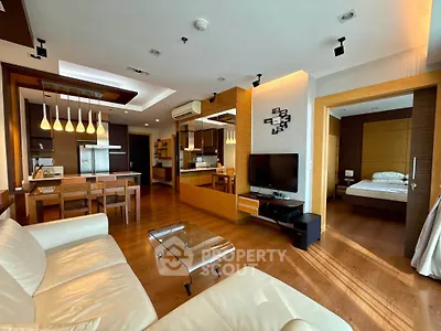 Luxurious open-plan living room with modern kitchen and cozy bedroom view