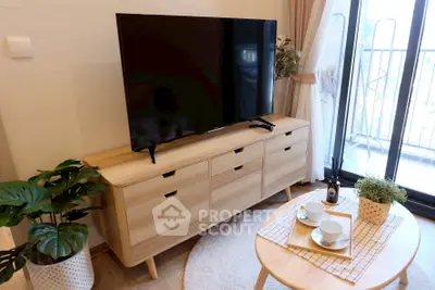 Chic living room with modern TV setup and balcony view