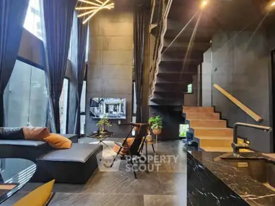 Luxurious modern living room with high ceilings and elegant staircase