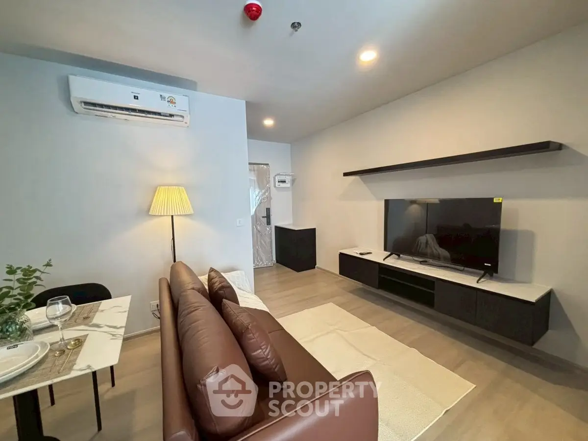 Modern living room with sleek furniture and ambient lighting, perfect for relaxation and entertainment.