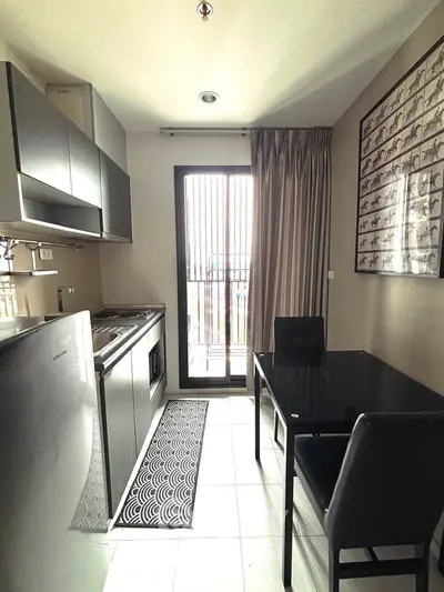 Modern kitchen with sleek appliances and dining area in a stylish apartment