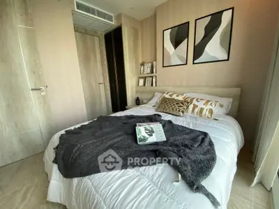 Modern bedroom with stylish decor and cozy bedding in a contemporary apartment.