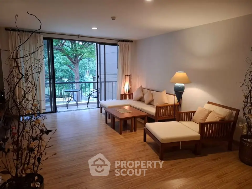 Elegant living room with wooden furniture and balcony view, perfect for relaxation and entertaining.