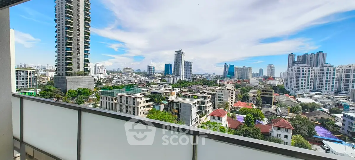 Stunning cityscape view from a high-rise balcony showcasing urban skyline and modern architecture.