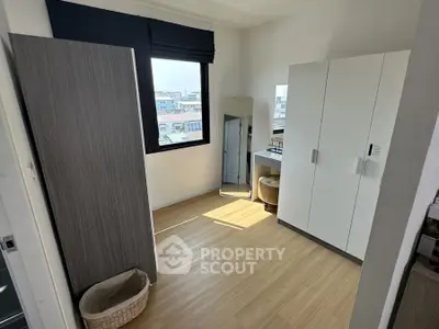 Bright bedroom with modern wardrobe and city view window