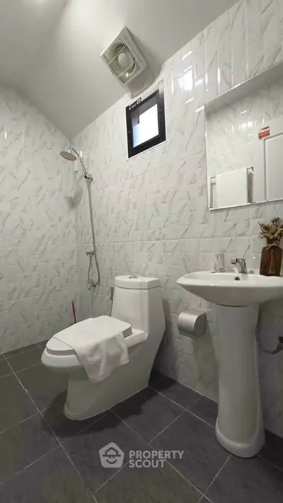 Modern bathroom with sleek fixtures and stylish tile design.