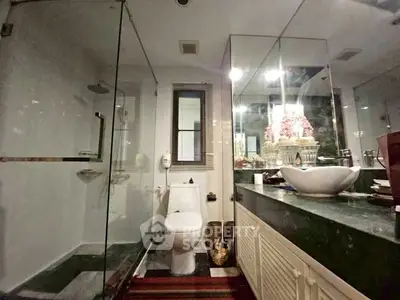 Luxurious bathroom with glass shower and elegant vanity in modern home.