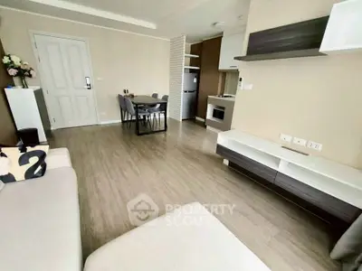 Modern living room with open kitchen and stylish decor in a contemporary apartment.