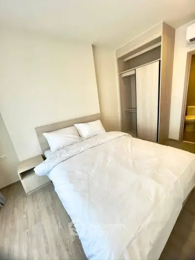 Modern bedroom with cozy bed and built-in wardrobe in a bright apartment