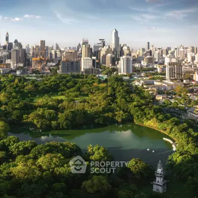 Stunning aerial view of a vibrant city skyline with lush green park and serene lake, perfect urban living.