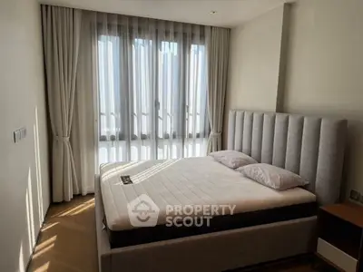 Modern bedroom with elegant curtains and plush bed in natural light
