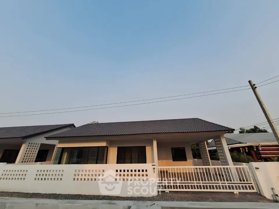 Charming single-story house with modern design and spacious front yard in a serene neighborhood.