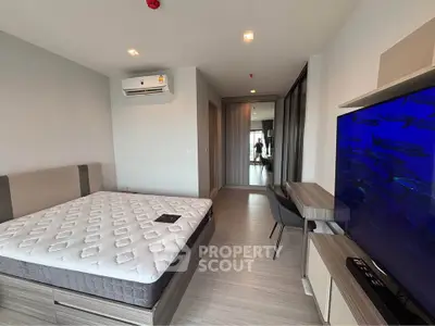 Modern bedroom with large bed, air conditioning, and stylish decor, perfect for comfortable living.