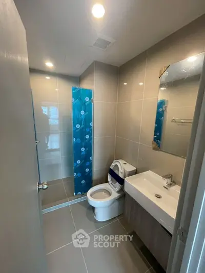Modern bathroom with sleek fixtures and glass shower enclosure