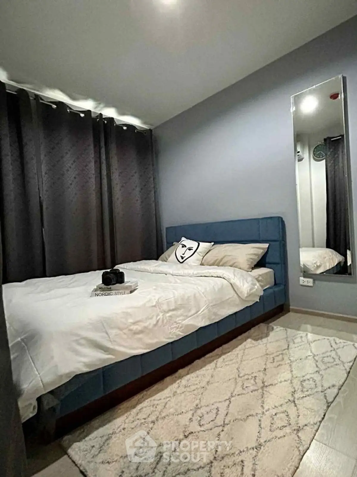 Cozy modern bedroom with stylish decor and plush bedding