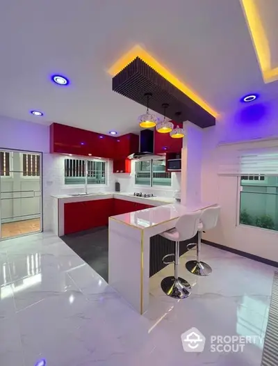 Modern kitchen with sleek red cabinets and stylish island bar seating