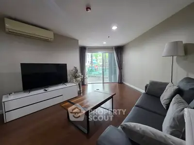 Modern living room with sleek furniture and balcony view