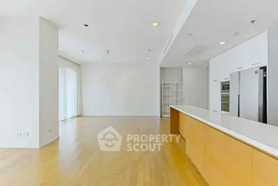 Spacious open-plan kitchen with modern appliances and wooden flooring