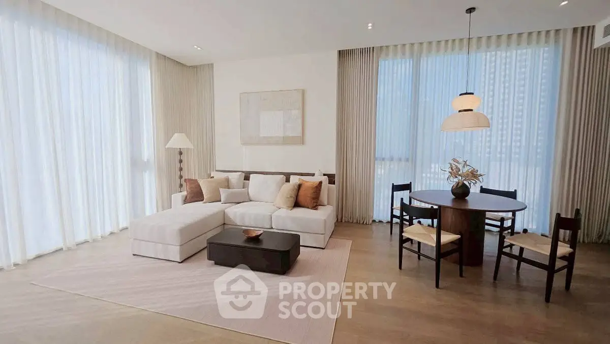 Spacious modern living room with elegant decor and large windows in a luxury apartment.