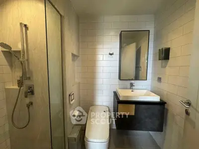 Modern bathroom with sleek fixtures and glass shower enclosure