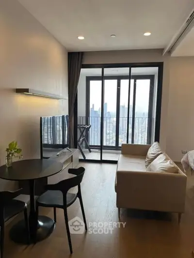 Modern living room with city view balcony, sleek furniture, and natural light.
