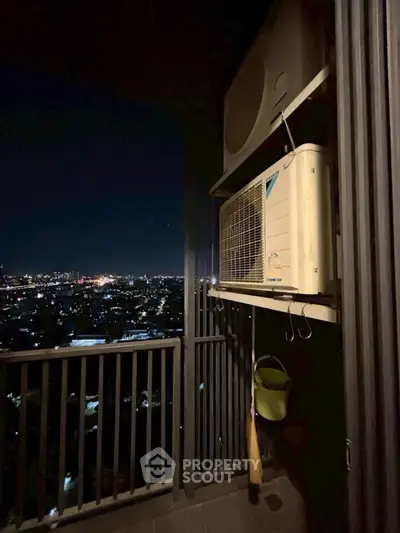 Stunning night city view from a high-rise balcony with air conditioning unit.